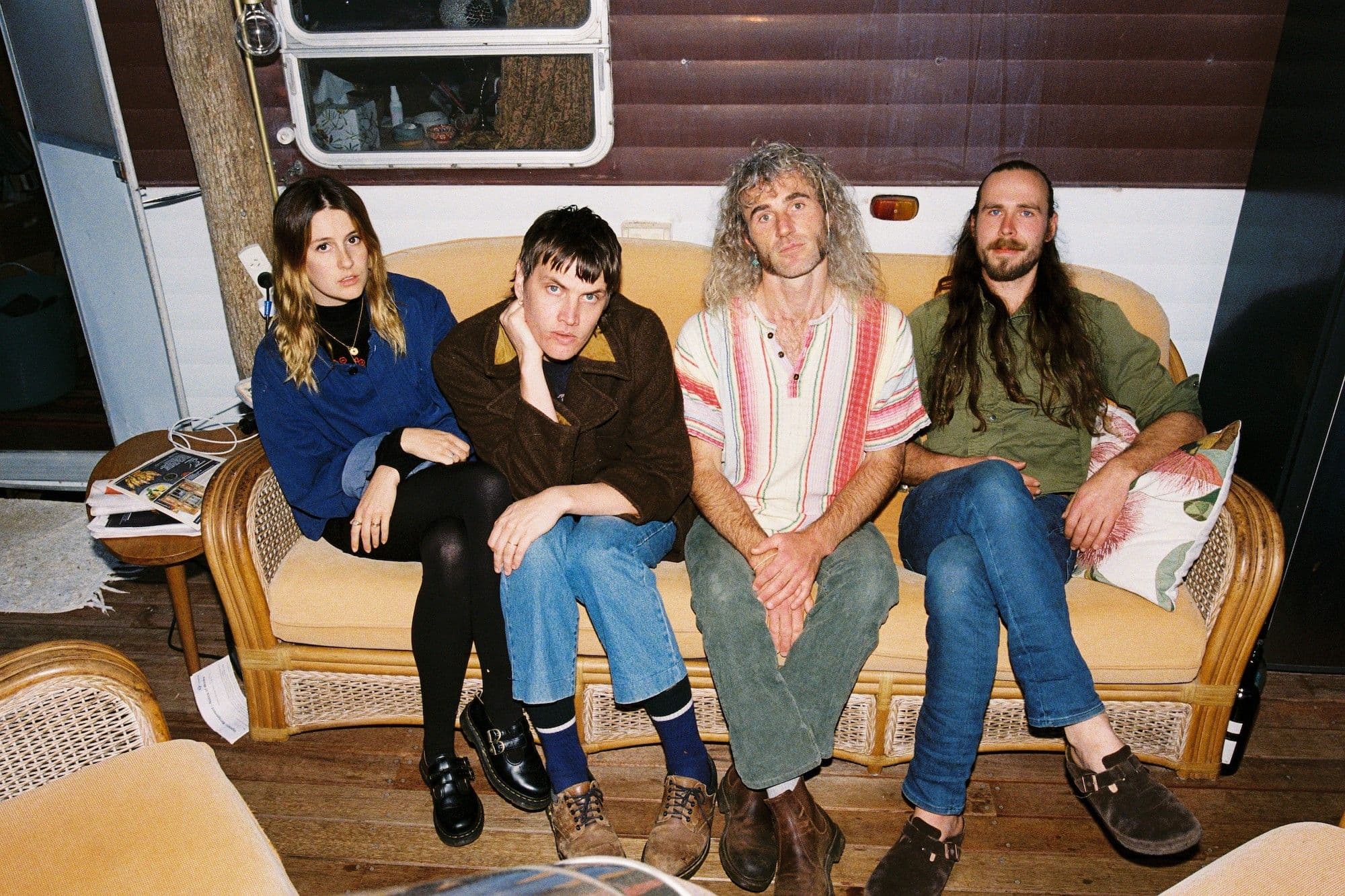 Four people sitting on a vintage lounge.