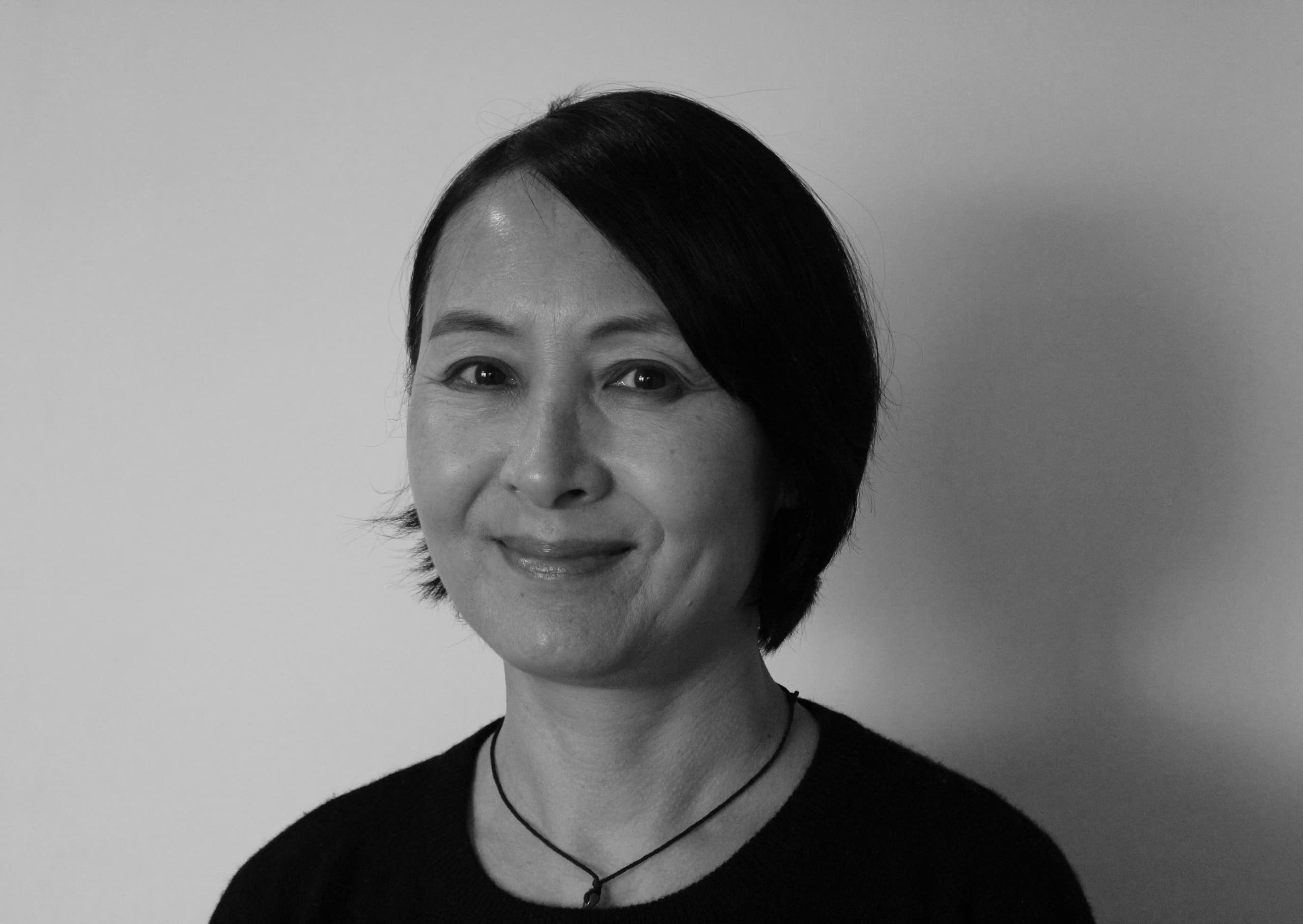 A woman smiling at the camera - black and white photo