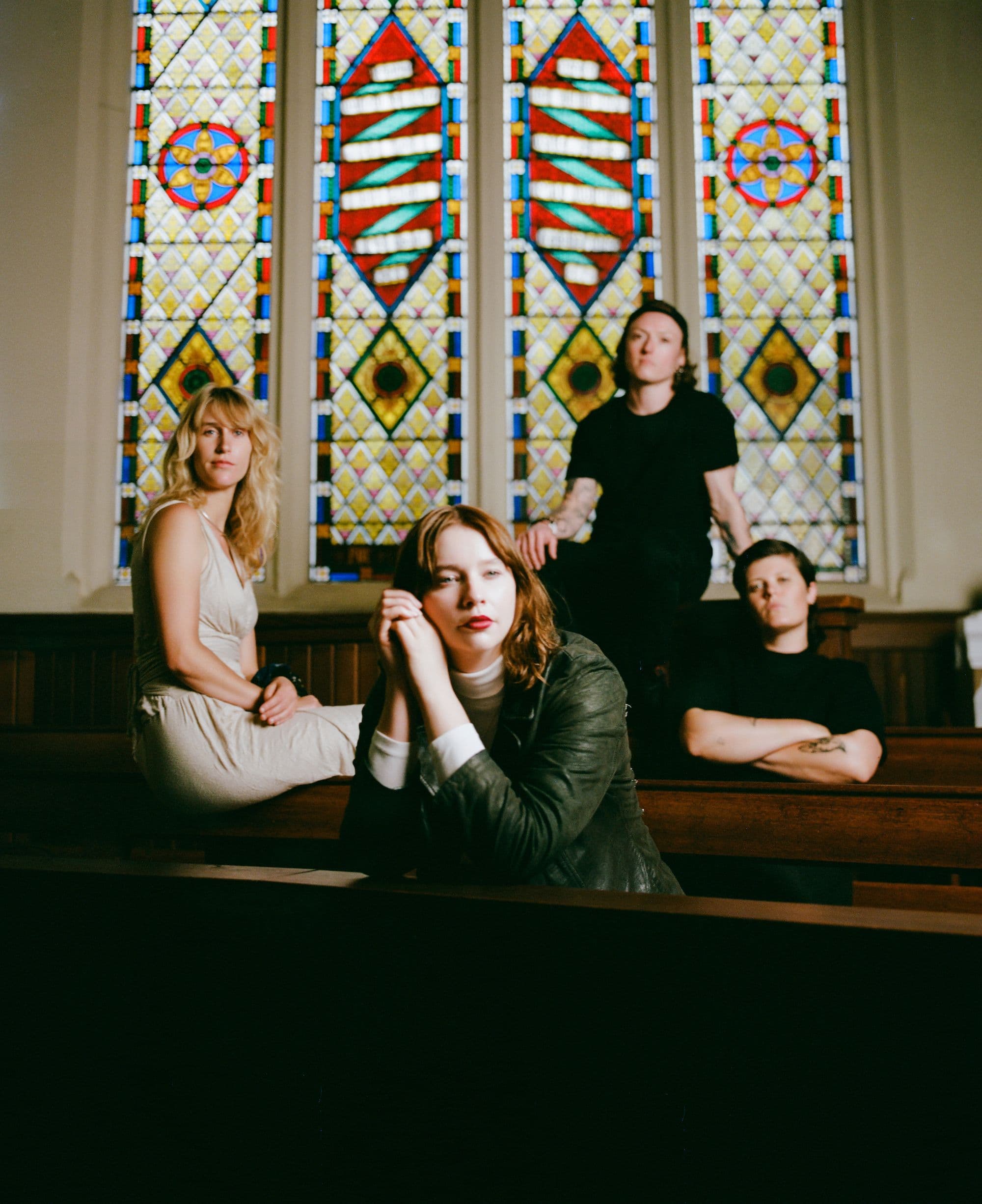 Four people in a church among the pews