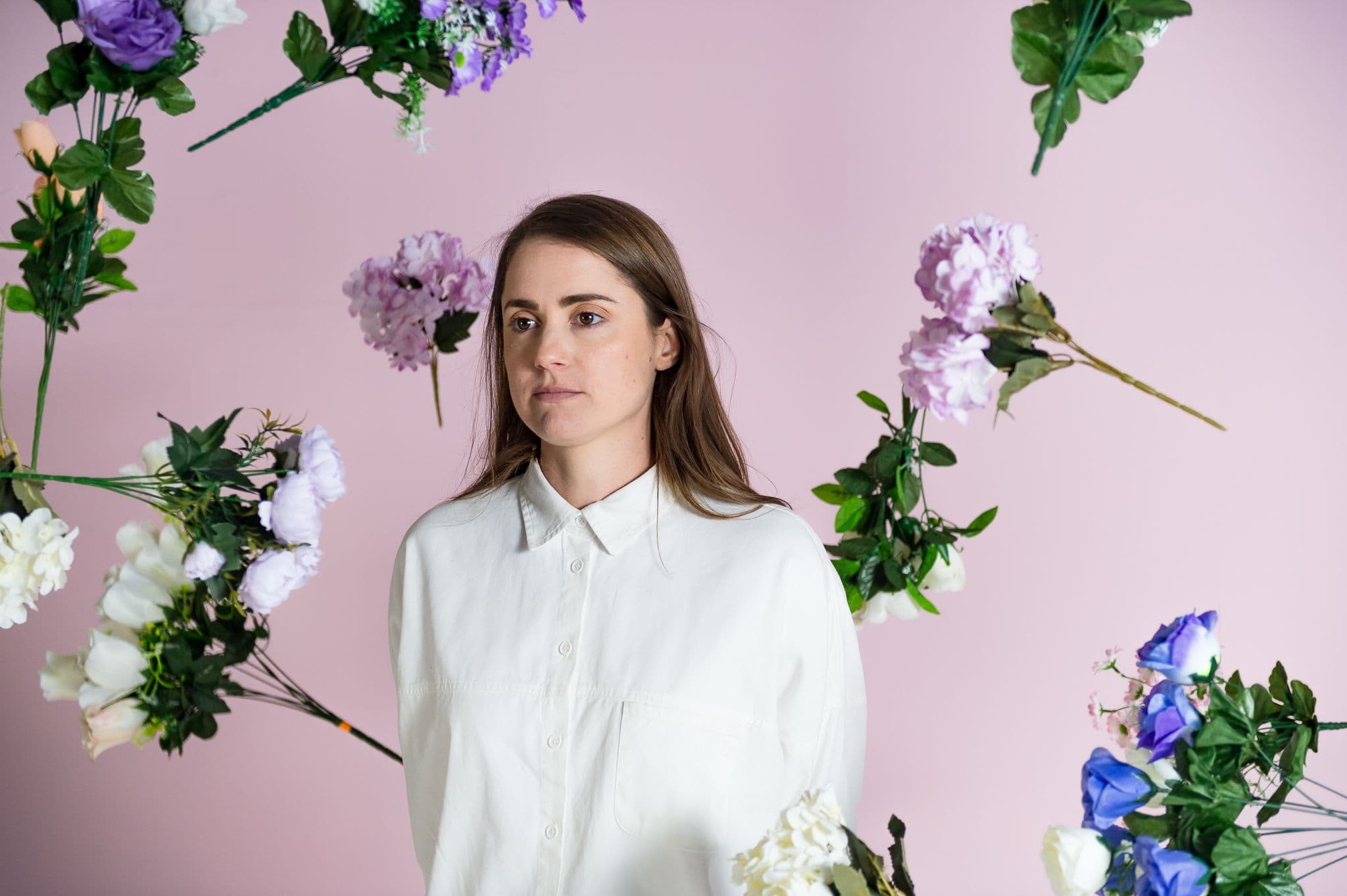 A woman with bunches of flowers falling in the background.